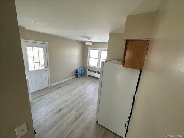 a view of room with window and wooden floor
