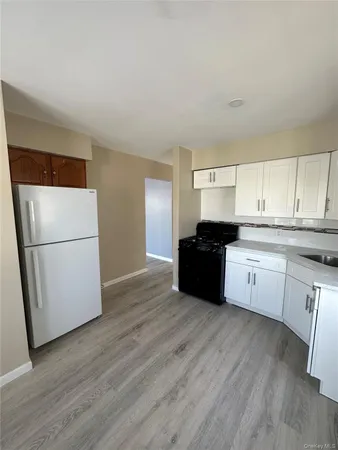 a kitchen with a refrigerator and a sink