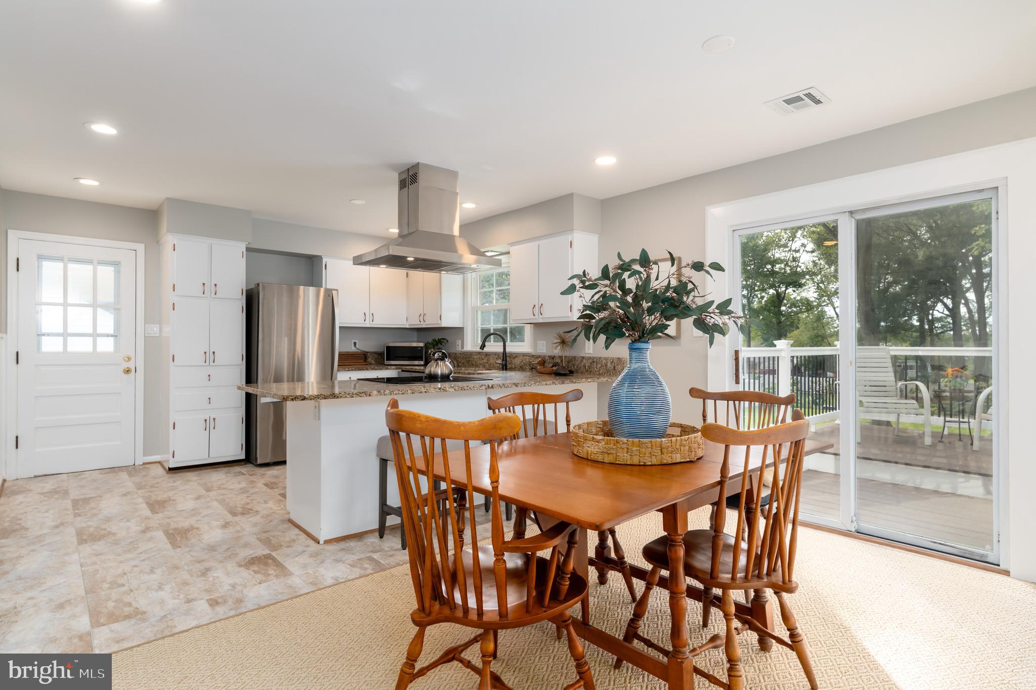 8528 Springman Street Alexandria, VA 22309 - Photo 8 of 29 Kitchen and dining opens up to new deck