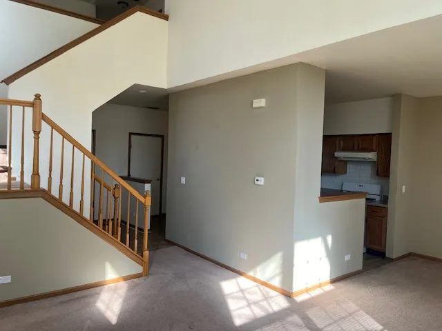 a view of staircase and kitchen with a sink
