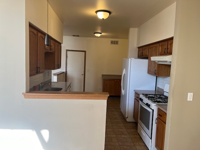 122 Polaris Drive Lake In The Hills, IL 60156 - Photo 7 of 23 a kitchen with stainless steel appliances a refrigerator and a stove