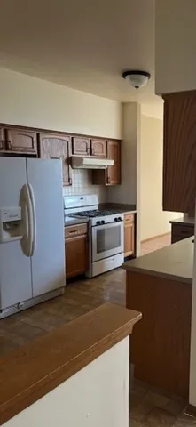 a kitchen with stainless steel appliances granite countertop a sink and a stove