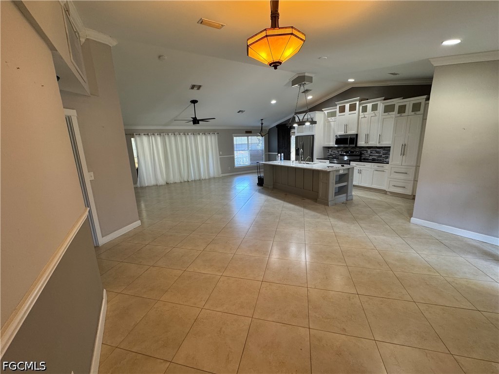 3313 35th Street West Lehigh Acres, FL 33971 - Photo 3 of 15 a living room with stainless steel appliances furniture a rug and a view of kitchen