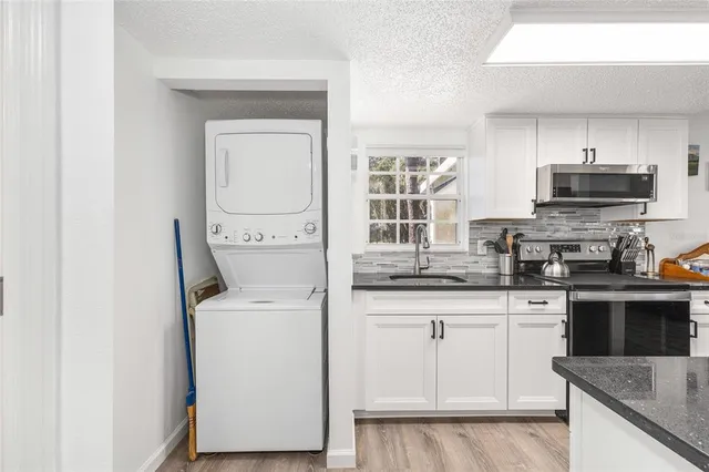a kitchen with a sink and a stove top oven