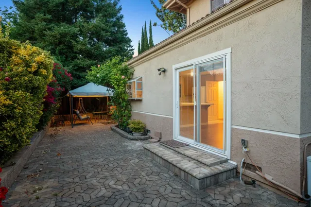 a view of a house with a yard and sitting area