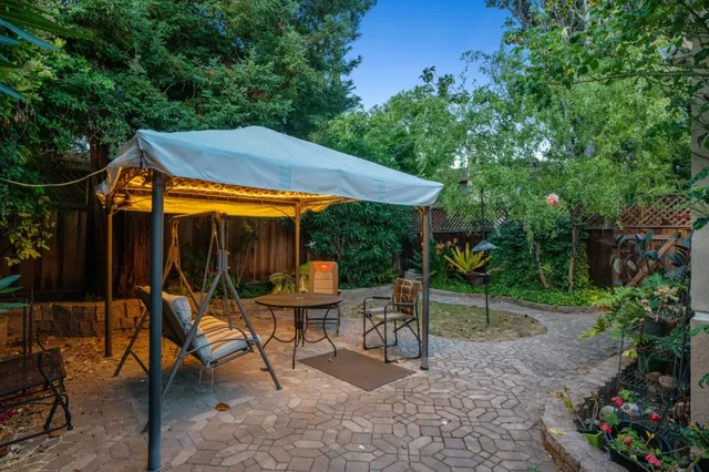 an empty room with wooden floor a fireplace and windows