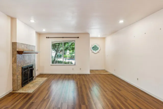 a view of a patio with table and chairs potted plants and large tree