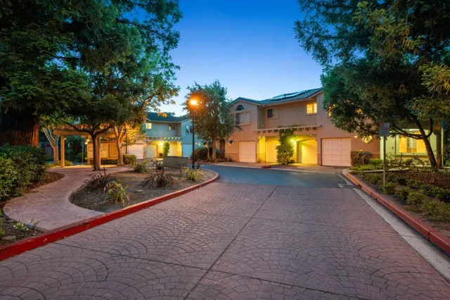 a view of a chair and table in backyard of the house