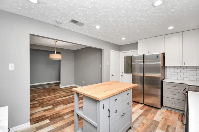 a kitchen with a refrigerator and countertop
