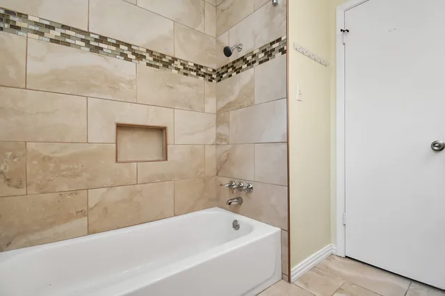 a bathroom with a bathtub and shower