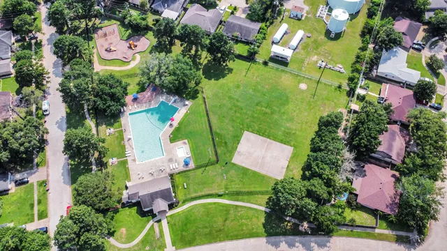 an aerial view of a house with swimming pool and garden