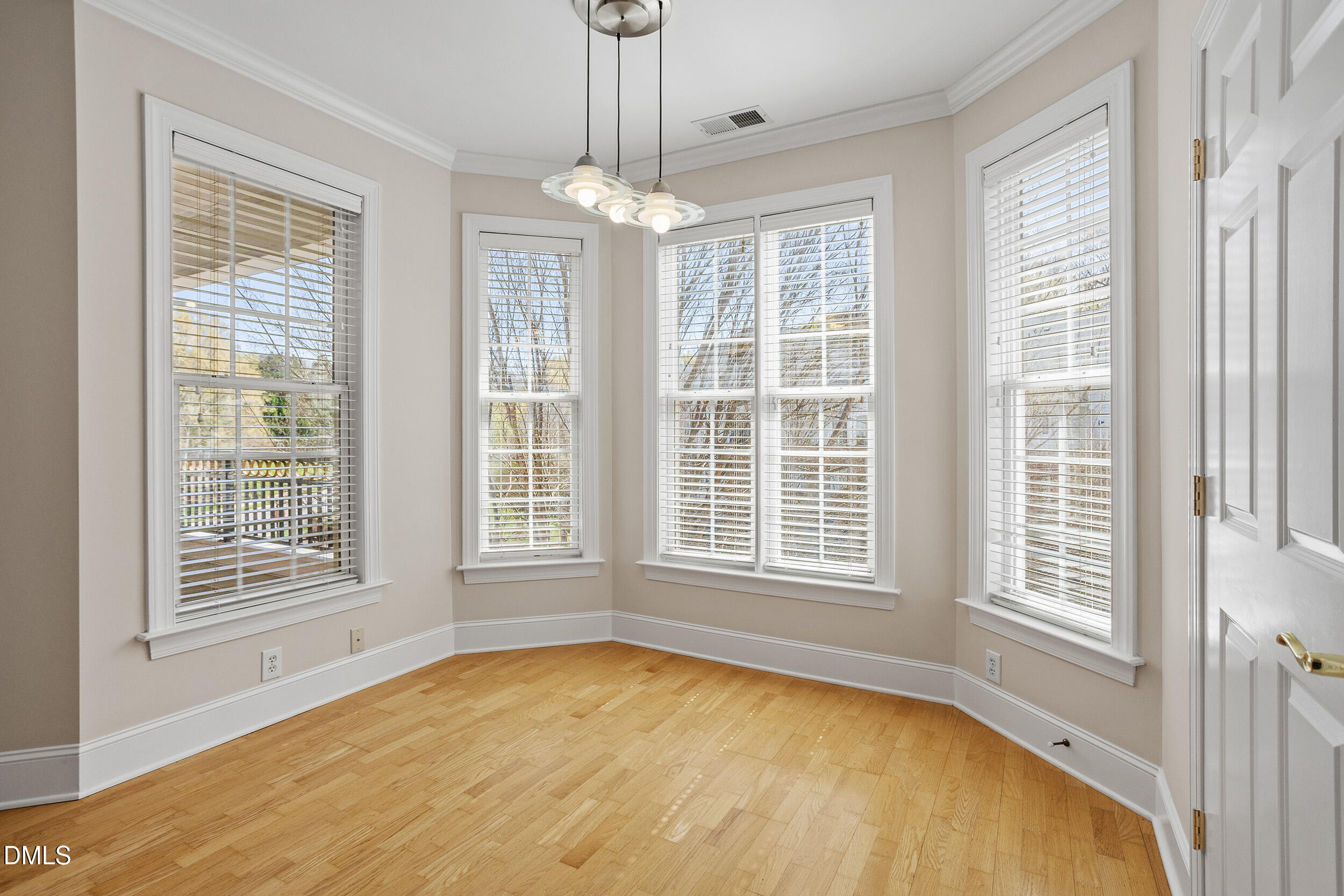 3700 Baron Cooper Pass, Unit 204 Raleigh, NC 27612 - Photo 20 of 45 a view of an empty room with a window and chandelier