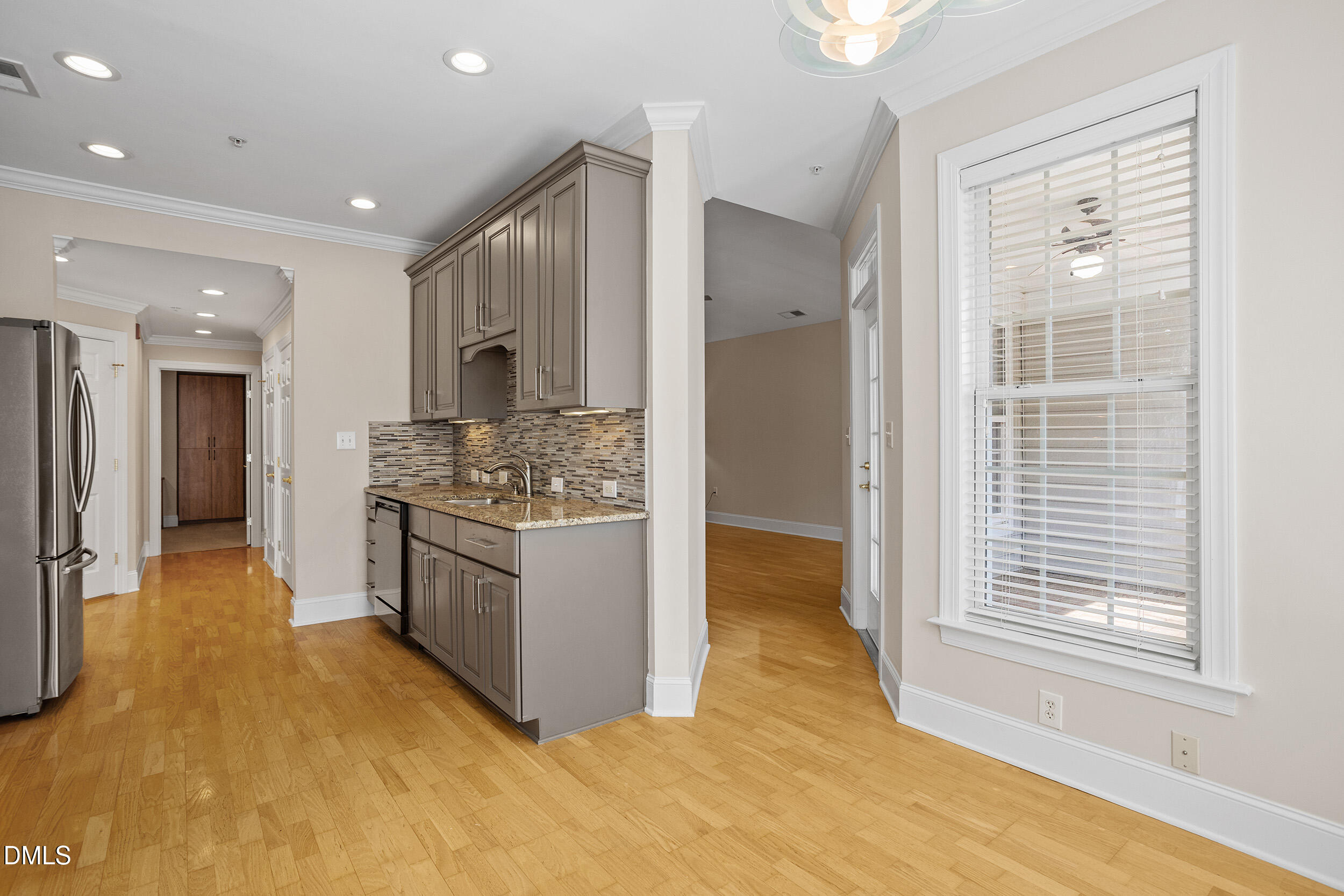 3700 Baron Cooper Pass, Unit 204 Raleigh, NC 27612 - Photo 21 of 45 a large kitchen with stainless steel appliances granite countertop a granite counter tops and a window