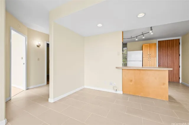 an empty room with a window and wooden floor