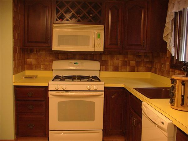 26 Harjean Road Billerica, MA 01821 - Photo 8 of 25 a kitchen with a sink stove and microwave