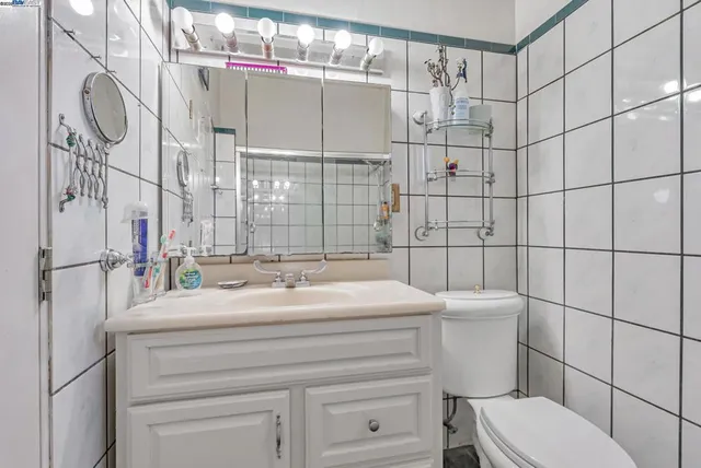 a bathroom with a toilet a sink and mirror