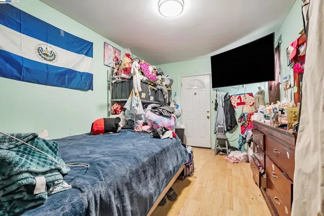 a bed room with a bed and a television