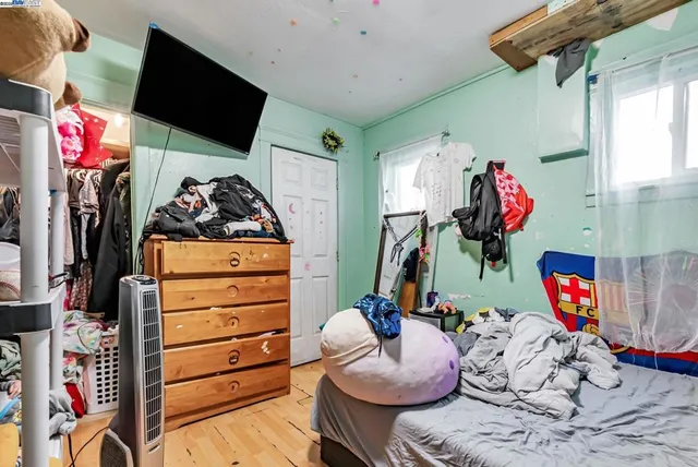 a bed sitting in a bedroom next to a window