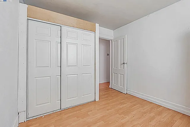 a bedroom with a bed and flat screen tv