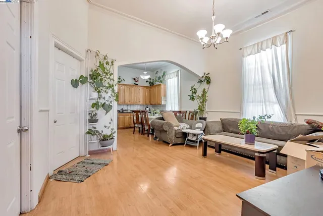 a living room with furniture and a chandelier