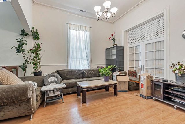 a living room with furniture and a chandelier