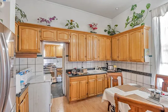 a kitchen with a sink stove and cabinets