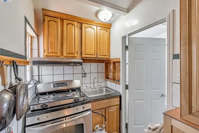 a kitchen with a stove and a refrigerator