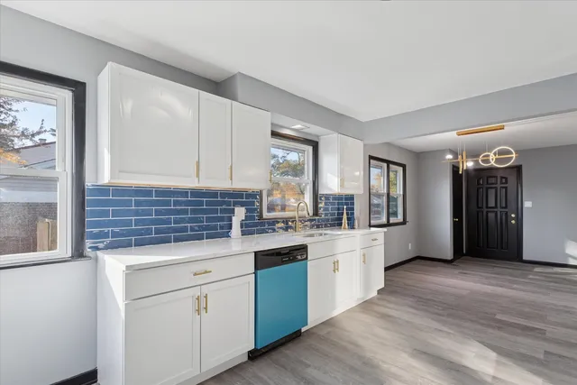 a kitchen with granite countertop a sink and cabinets