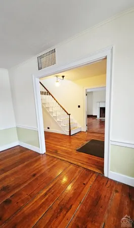 an empty room with windows and ceiling fan