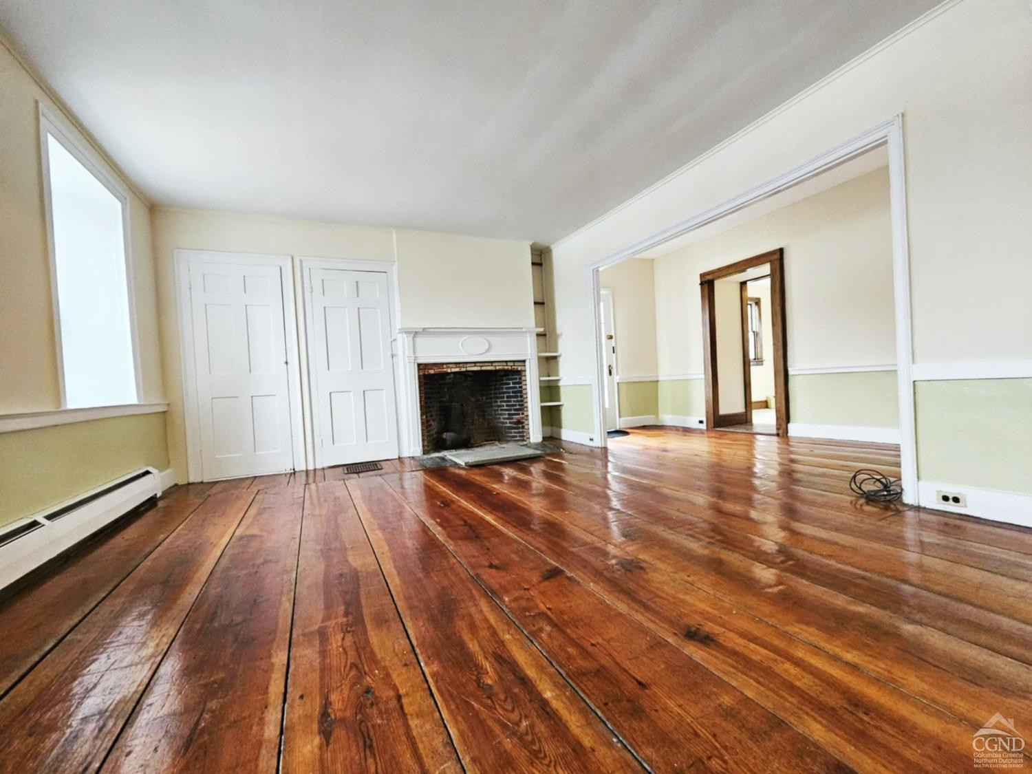 274 Fingar Road Hudson, NY 12534 - Photo 18 of 87 an empty room with wooden floor and fireplace