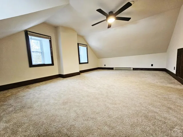 an empty room with windows and closet