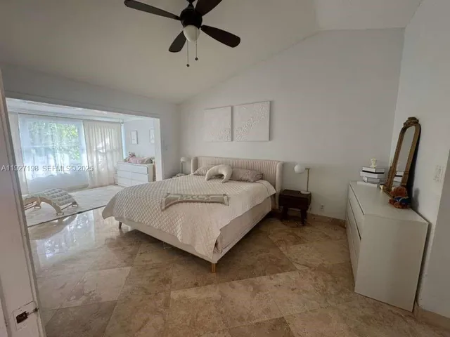 a bedroom with a bed a couch and dresser