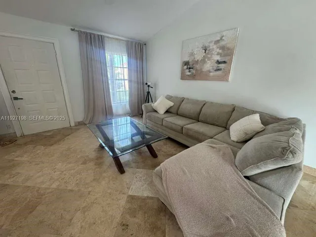 a living room with furniture and a window