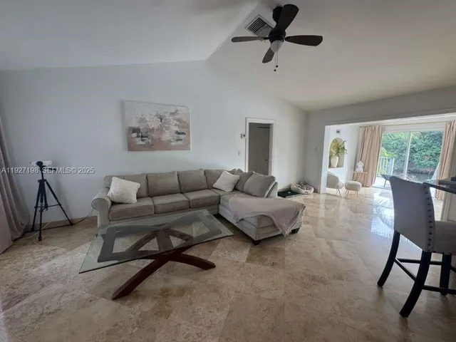 a living room with furniture and a window