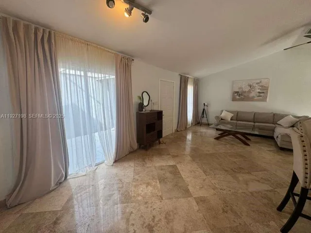 a living room with furniture and a window