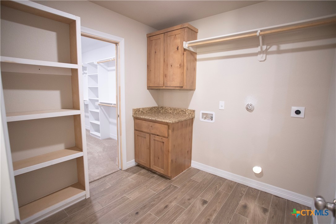 3213 Digby Drive Belton, TX 76513 - Photo 16 of 18 a view of walk in closet with wooden floor