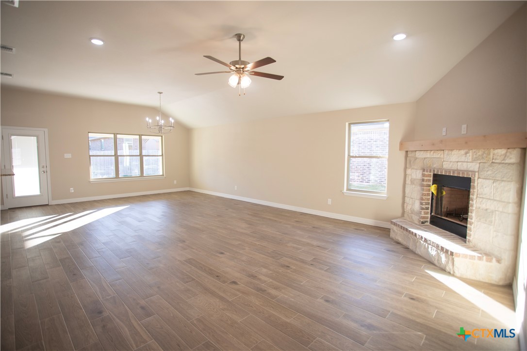 3213 Digby Drive Belton, TX 76513 - Photo 3 of 18 an empty room with wooden floor fireplace and windows