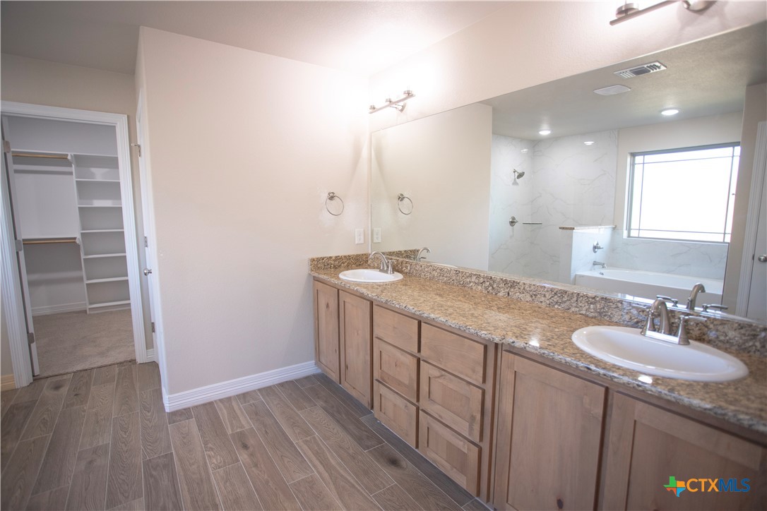 3213 Digby Drive Belton, TX 76513 - Photo 7 of 18 a bathroom with a granite countertop sink and a mirror