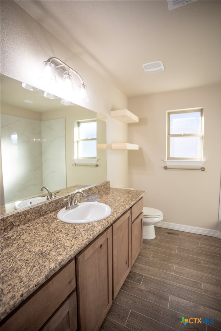 3213 Digby Drive Belton, TX 76513 - Photo 10 of 18 a bathroom with a granite countertop sink and a mirror