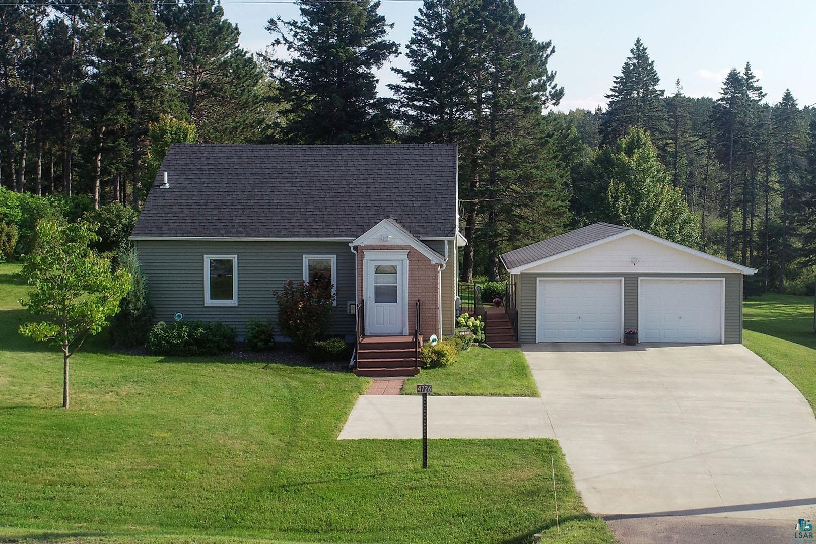 4726 Hermantown Road Hermantown, MN 55811 - Photo 1 of 40 View of front facade with a garage, a front lawn, and an outbuilding