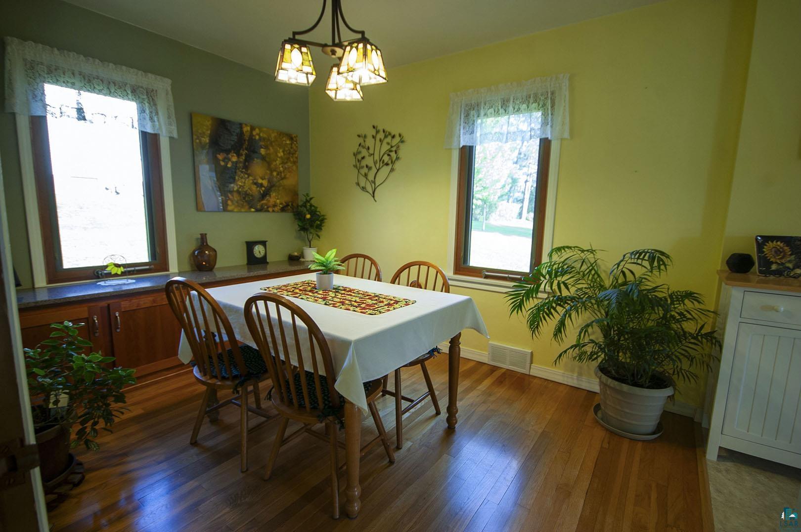 4726 Hermantown Road Hermantown, MN 55811 - Photo 17 of 40 Dining room with dark wood-type flooring and an inviting chandelier