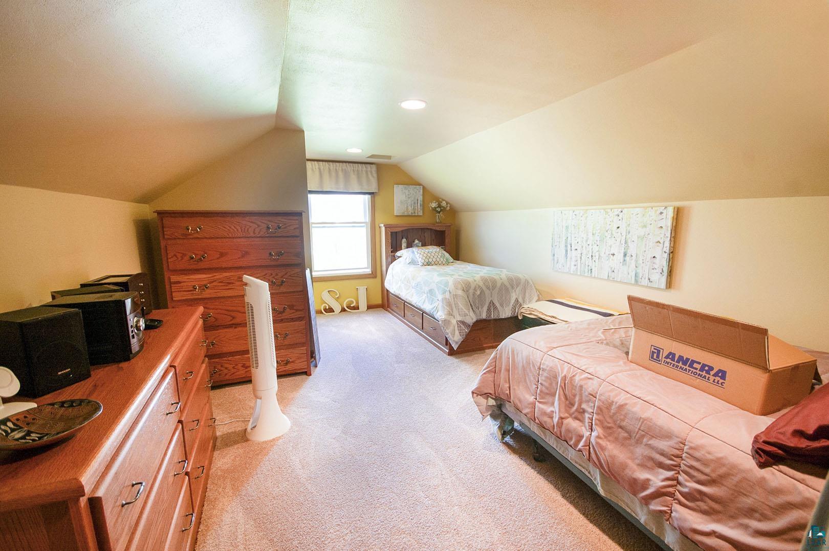 4726 Hermantown Road Hermantown, MN 55811 - Photo 25 of 40 Bedroom with light carpet and vaulted ceiling