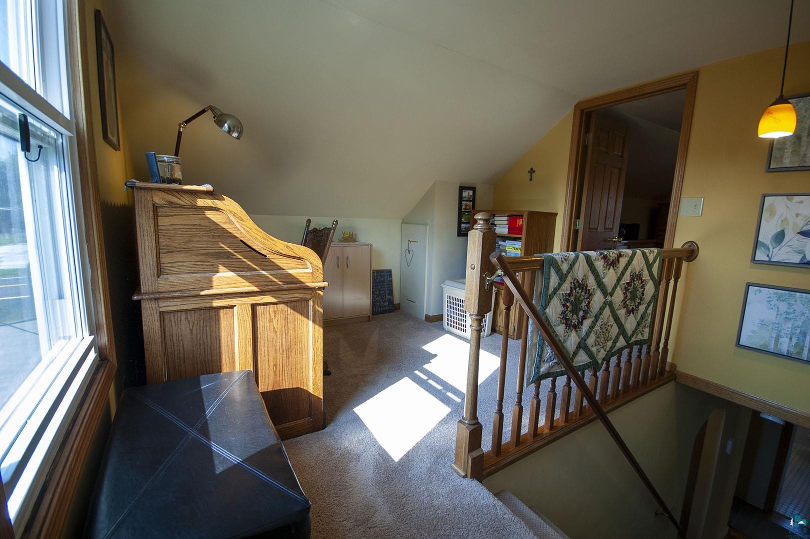 4726 Hermantown Road Hermantown, MN 55811 - Photo 27 of 40 Interior space featuring carpet flooring and vaulted ceiling