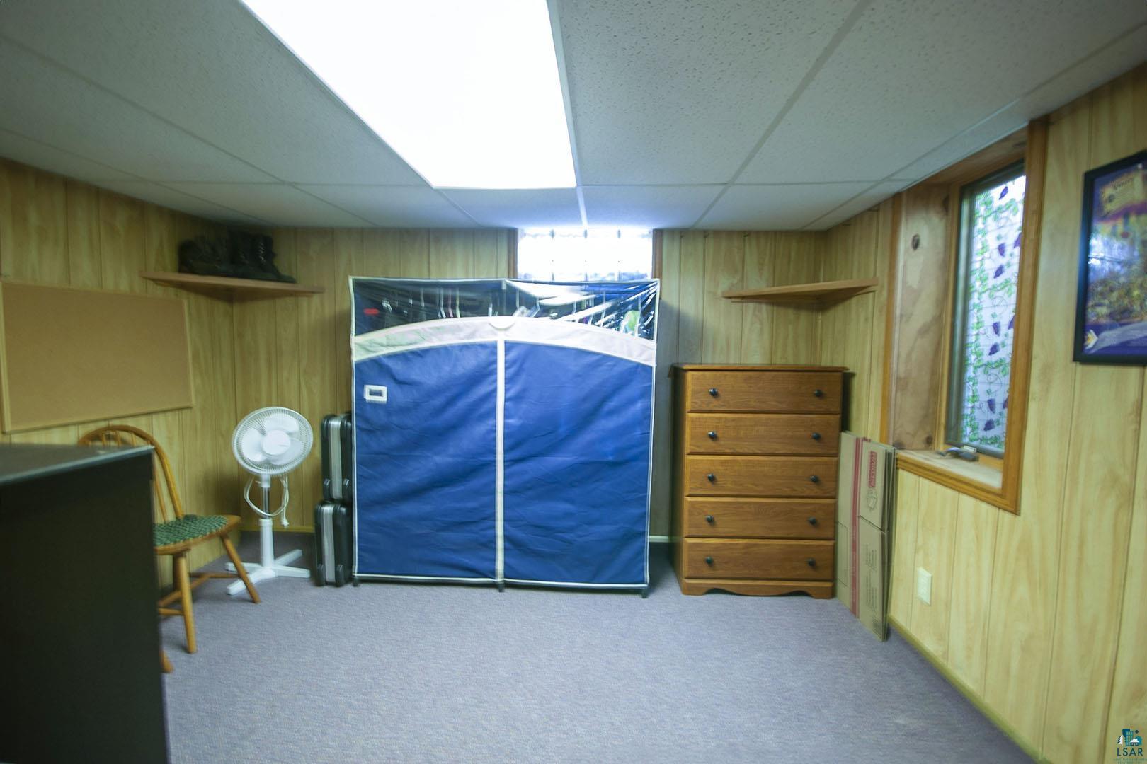 4726 Hermantown Road Hermantown, MN 55811 - Photo 36 of 40 Bedroom with carpet flooring, wood walls, and a paneled ceiling