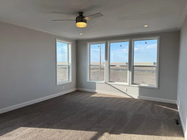 a kitchen with granite countertop a sink a counter top space stainless steel appliances and cabinets