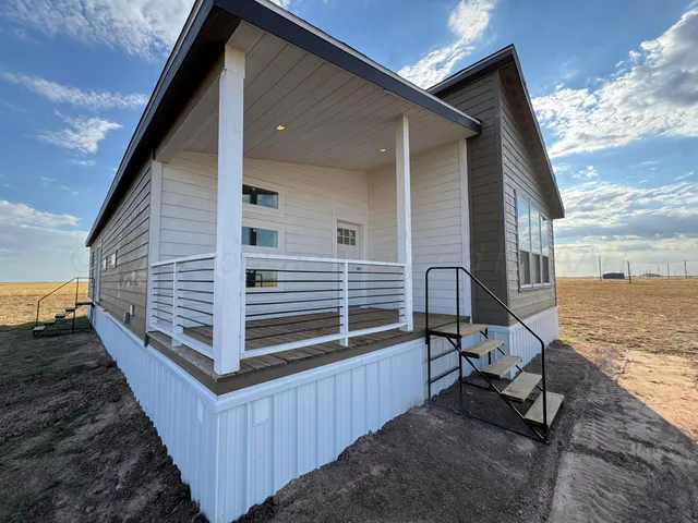 a view of a house with a yard and wooden floor
