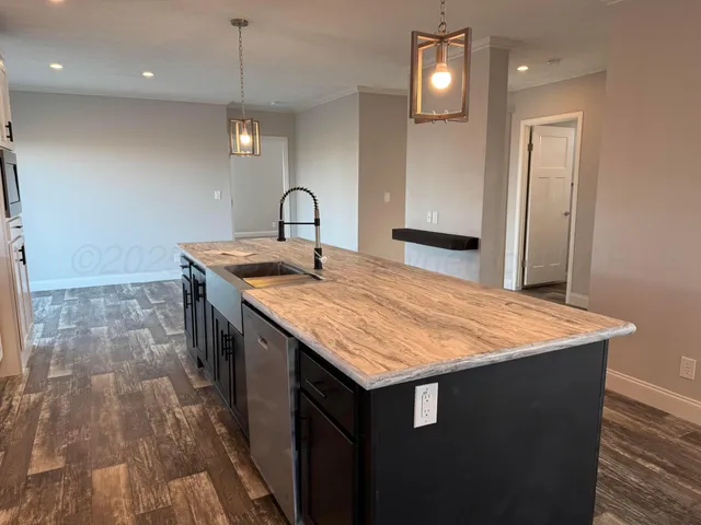 a bathroom with a granite countertop sink a toilet and a bathtub