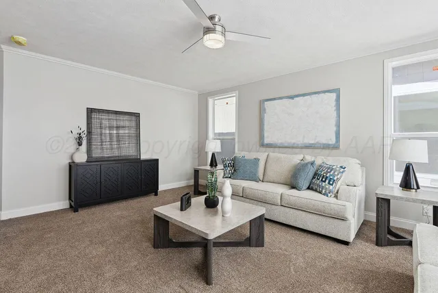 a kitchen with kitchen island granite countertop a sink and refrigerator