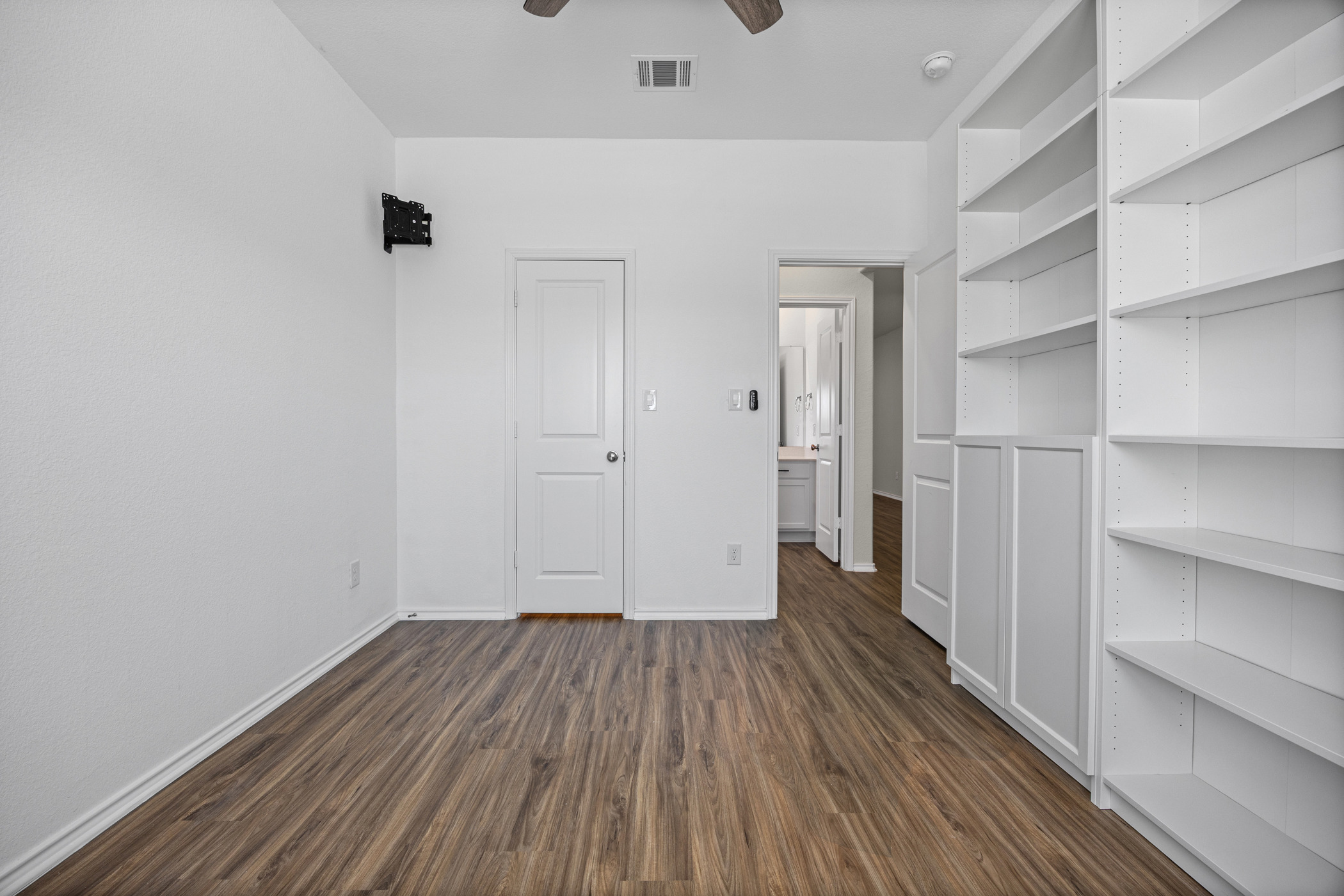 1609 Woolsey Way Leander, TX 78641 - Photo 11 of 29 Unfurnished bedroom featuring dark wood-style flooring and a ceiling fan