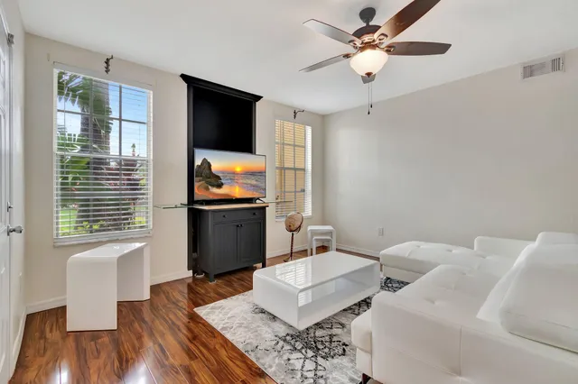 a view of a a dining room with furniture window and wooden floor
